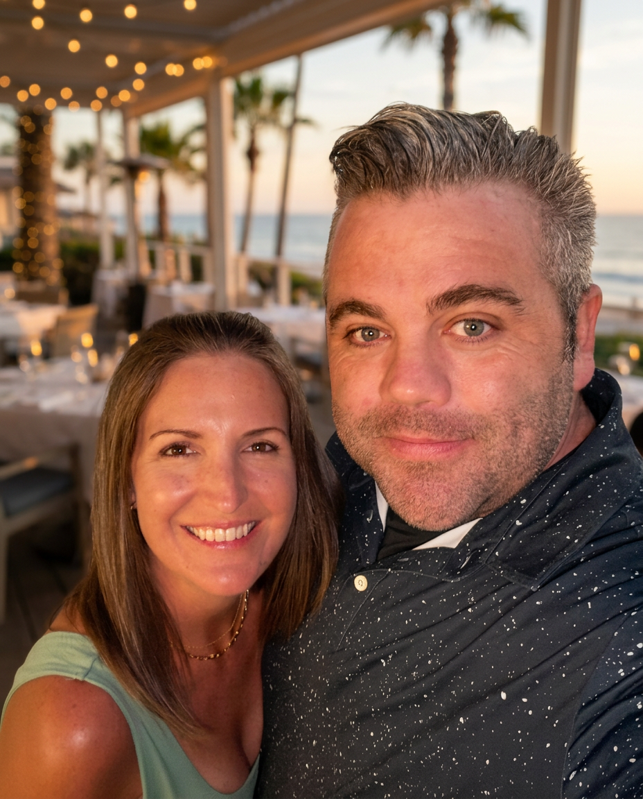 Jeremy and Crystal, owners of First Response Voyages, at a coastal restaurant at golden hour